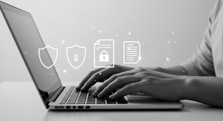 Protecting Digital Data: Person Typing on a Laptop with Data Security Icons