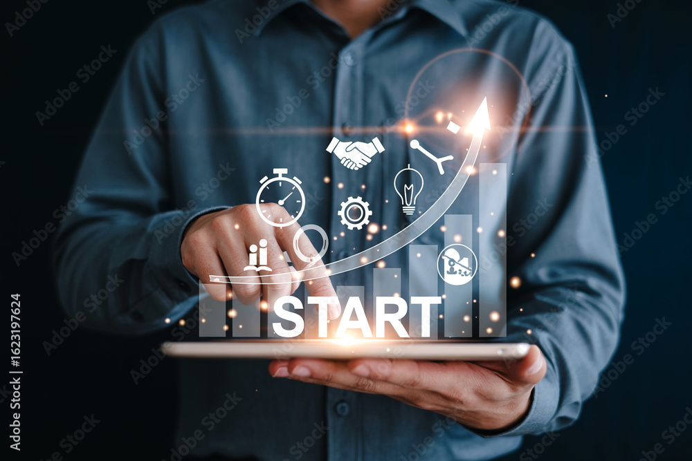 Aufkleber businessman using a tablet with virtual start up icons and growth graph representing project initiat