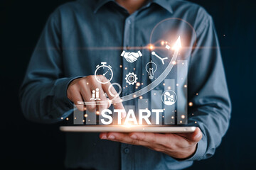 Businessman using a tablet with virtual start up icons and growth graph representing project initiation and business development strategies for success