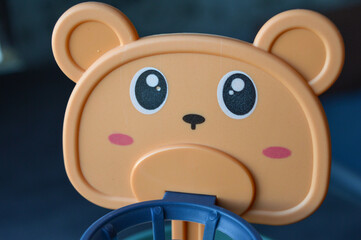 assembled colorful plastic ball ramp toy with bear face and spiral tracks. yellow balls rest on the base, ready to roll down. educational and playful design for young children.