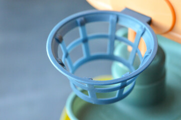 assembled colorful plastic ball ramp toy with bear face and spiral tracks. yellow balls rest on the base, ready to roll down. educational and playful design for young children.