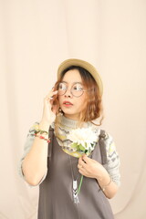 Studio lookbook with vintage dresses, soft lighting, and feminine styling on a plain backdrop.