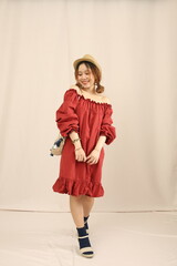 Studio lookbook with vintage dresses, soft lighting, and feminine styling on a plain backdrop.