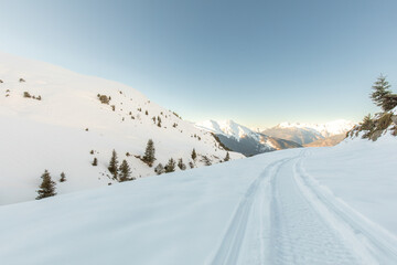Snowmobile trail winding through snowy mountains
