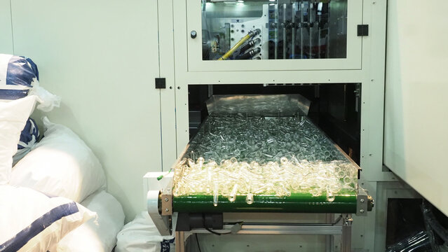 A plastic injection molding machine producing clear plastic preforms