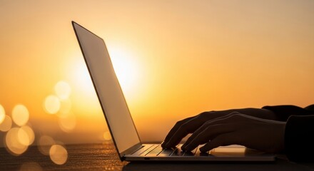Sunset Laptop Work - Silhouette of hands typing on a laptop at sunset, peaceful outdoor workspace