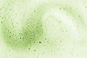 Matcha foam texture in macro detail with green tones