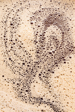 Macro view of frothy coffee foam surface pattern