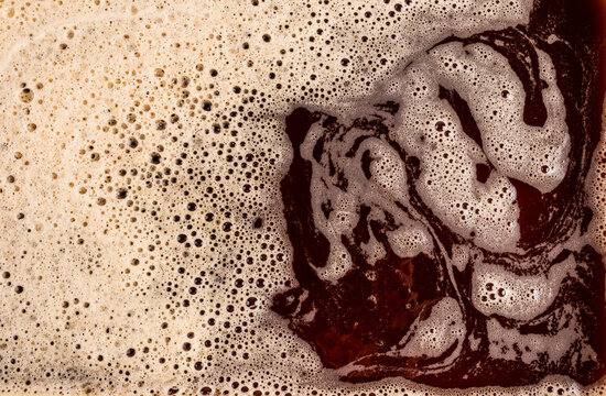 Macro texture of foamy coffee surface with bubbles