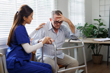 The doctor or Nurse wearing a white coat with a stethoscope is holding the hand of a patient in a...