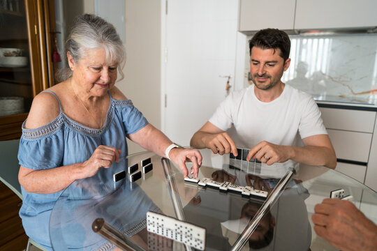 Multigenerational family enjoying a game of dominoes