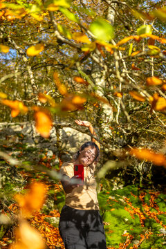 Woman hiking through autumn forest in Gorbea Park