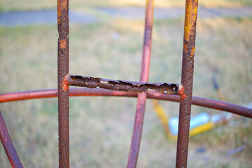 Rusty and damaged iron pipes in the playground