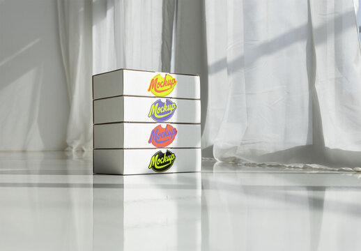 A stack of cardboard boxes arranged neatly, ready for delivery in a bright, modern space with sunlight streaming through sheer curtains. PSD template mockup.