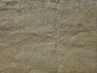 natural beige burlap fabric texture with visible weave pattern for eco product packaging or rustic background design

