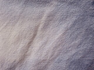 closeup of gray textured woven fabric with soft folds and natural lighting ideal for textile...