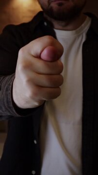 Man making fist gesture named figa. Man insults his offender with a hand sign