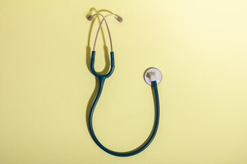 Stethoscope on yellow background symbolizing healthcare