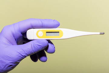 Healthcare professional holding digital thermometer