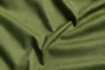Olive Green Ripstop Polyester Fabric with Sharp Creases and Directional Shadows – High Detail Macro Texture