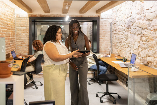 Multiracial team collaborating in modern coworking space