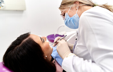 Dentist examining patient in clinic setting