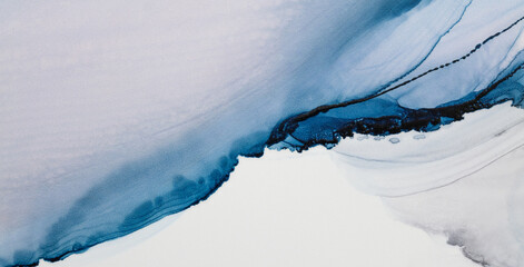 Stunning blue alcohol ink artwork showcasing fluid movement and color depth on a white surface