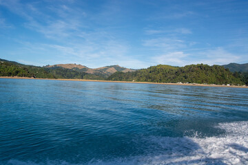Tranquil Coastal Landscape with Blue Sea and Green Hills