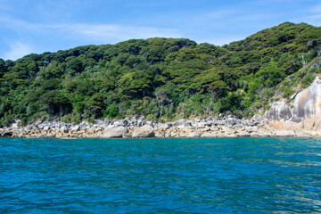 Serene Coastal Landscape with Lush Green Hills and Blue Ocean
