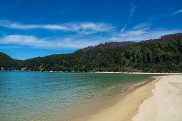 Serene Beach with Turquoise Waters and Lush Hills