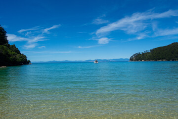 Fototapeta premium Serene Beach with Turquoise Waters and Distant Boat