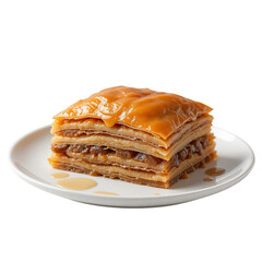 Caramel glazed baklava dessert on a white plate Layers of flaky pastry with nut filling
