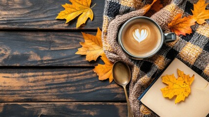Warm coffee mug nestled in plaid blanket with scattered oak and birch leaves on wooden table. Autumn