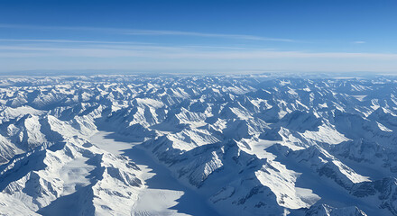 Vast snow covered mountain range under a clear blue sky mountains white