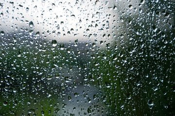 Close-up of raindrops outside of bedroom window during a summer thunderstorm at Swiss city of Zürich. Photo taken August 1st, 2025, Zurich, Switzerland.