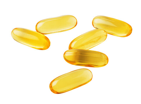 Fish oil capsules falling on transparent background