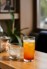 Refreshing summer cocktails drinks: tequila sunrise and white russian on wooden table top