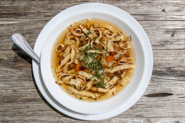 a soup (Frittatensuppe) served on a white plate at a mountain hut 