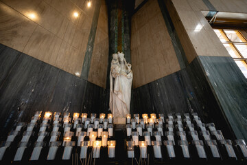 Interior view of basilica with arches, pews, and soft lighting.