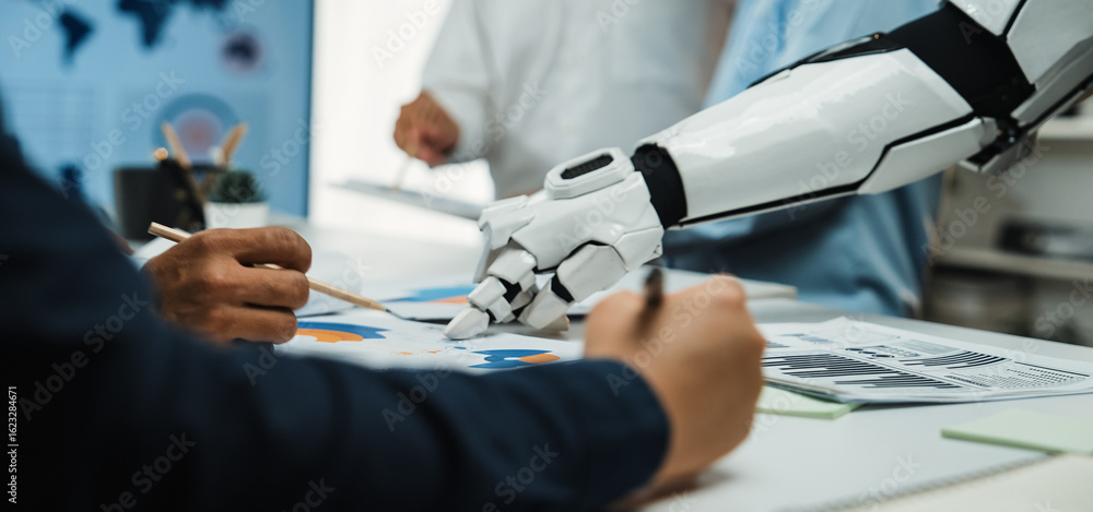 Poster human and robot collaborate during a meeting, analyzing data charts on a table, showcasing the integ