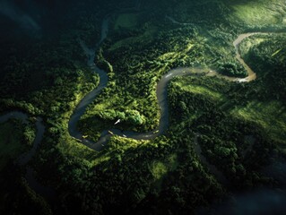 Obraz premium Aerial view of a winding river through a lush green forest at dusk