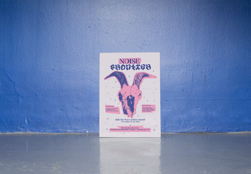 Mockup of blank A3 vertical poster is leaning against a bright blue wall