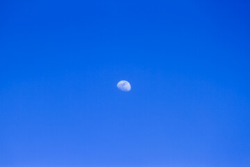 Beautiful crescent moon in a clear afternoon sky over Longgang Miaoli Taiwan, captured in summer 2011, ideal for serene landscape designs.