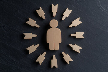 Wooden figure surrounded by arrows. A visual metaphor for stress, pressure, or being targeted, set against a dark background, symbolizing challenges or threats.