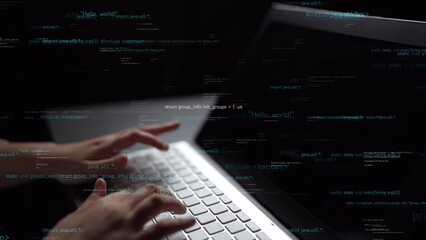 A close-up view captures hands typing on a laptop keyboard, surrounded by floating lines of code in...