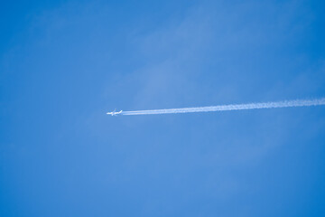 a jet airliner aircraft in a blue sky