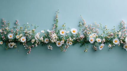 Delicate floral arrangement of white daisies and small wildflowers.