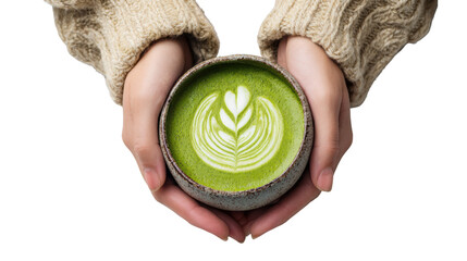 Hands holding a bowl of green matcha latte with decorative leaf pattern, over white isolated background.