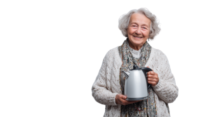 Smiling elderly woman holding a kettle, wearing a cozy sweater, isolated on white background.