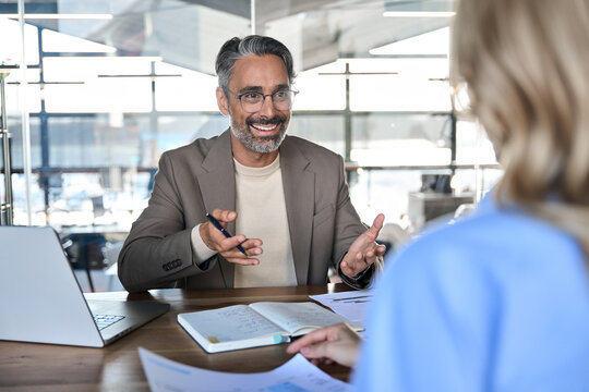 Fototapeta Business interview concept. Happy middle aged professional business man executive hr, bank manager, lawyer or financial advisor having job interview meeting with client in corporate office.
